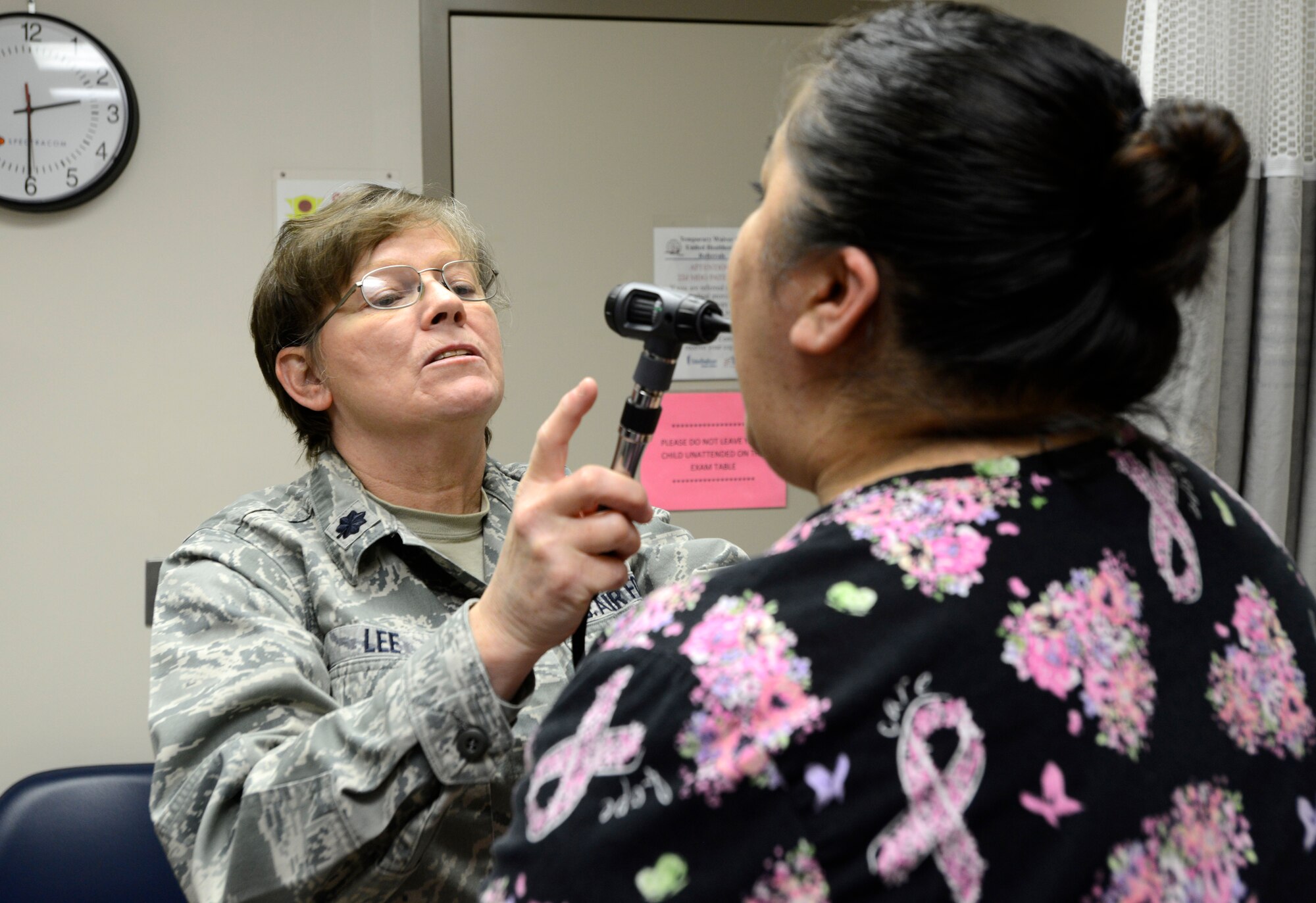 Lt. Col. Susan Lee, 22nd Medical Operations Squadron Family Nurse Practitioner, looks into a patient’s mouth during an exam, April 20, 2015, at McConnell Air Force Base, Kan. Lee leads a primary care management team which includes two other FNPs, that serves more than 11,000 beneficiaries across Team McConnell. (U.S. Air Force photo by Senior Airman Trevor Rhynes)
