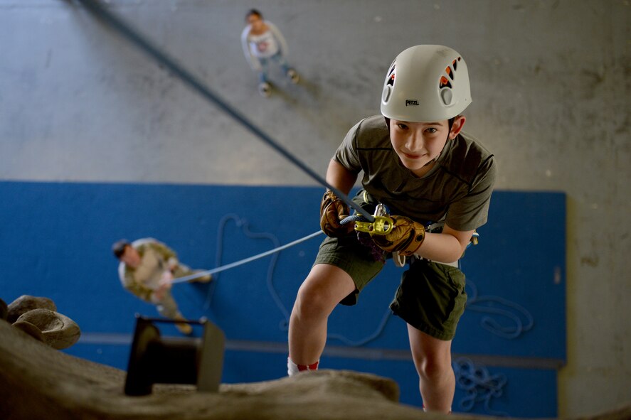 A Boy Scout from Troop 007 repels down a rock wall, April 18, 2015, at Joint Base Lewis-McChord, Wash. The Boy Scouts are a youth development organization that focuses on volunteering, leadership, and working as a team. (U.S. Air Force photo/Airman 1st Class Keoni Chavarria)