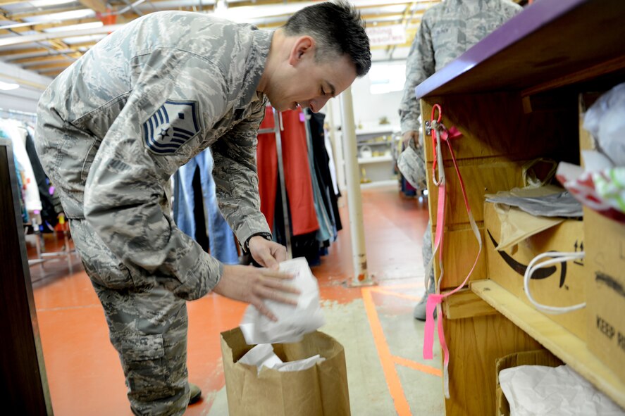 Master Sgt. Jay Redfern, 5th Air Support Operations Squadron first sergeant, picks up cookies to deliver to Airmen, April 17, 2015, at Joint Base Lewis-McChord, Wash. The McChord Spouses Club and first sergeants on McChord Field wanted to show Airmen in the dorms that have support and that they are appreciated. (U.S. Air Force photo/Airman 1st Class Keoni Chavarria)