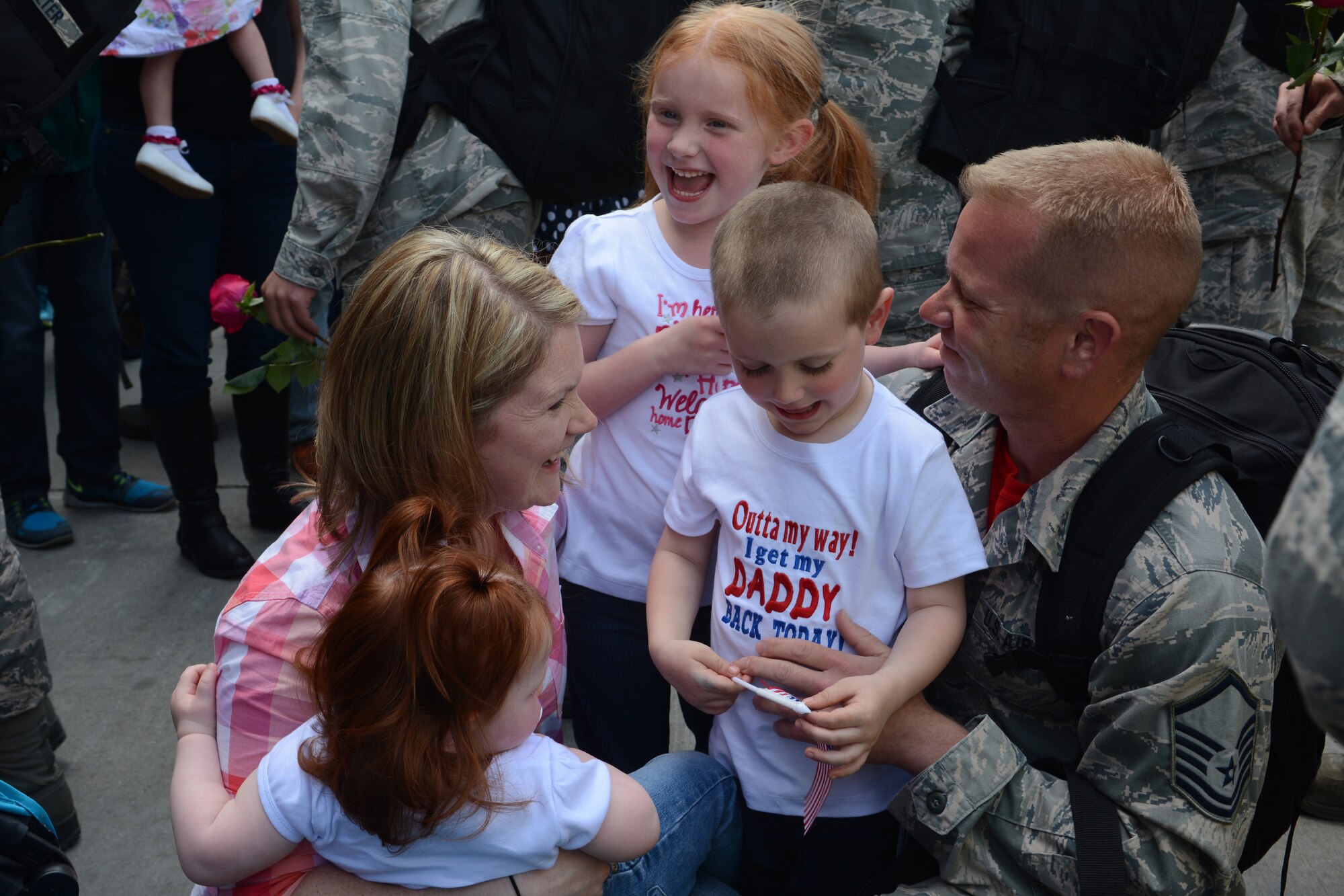 A family greets its 115th Fighter Wing Airman upon arrival in Hangar 406 in Madison, Wis., April 19, 2015. More than 250 Airmen were welcomed home by family, friends and the community. The Airmen were deployed for four months to Kadena Air Base in Okinawa, Japan, in support of the Pacific Command Theater Security Package. (U.S. Air National Guard photo by Senior Airman Andrea F. Rhode)