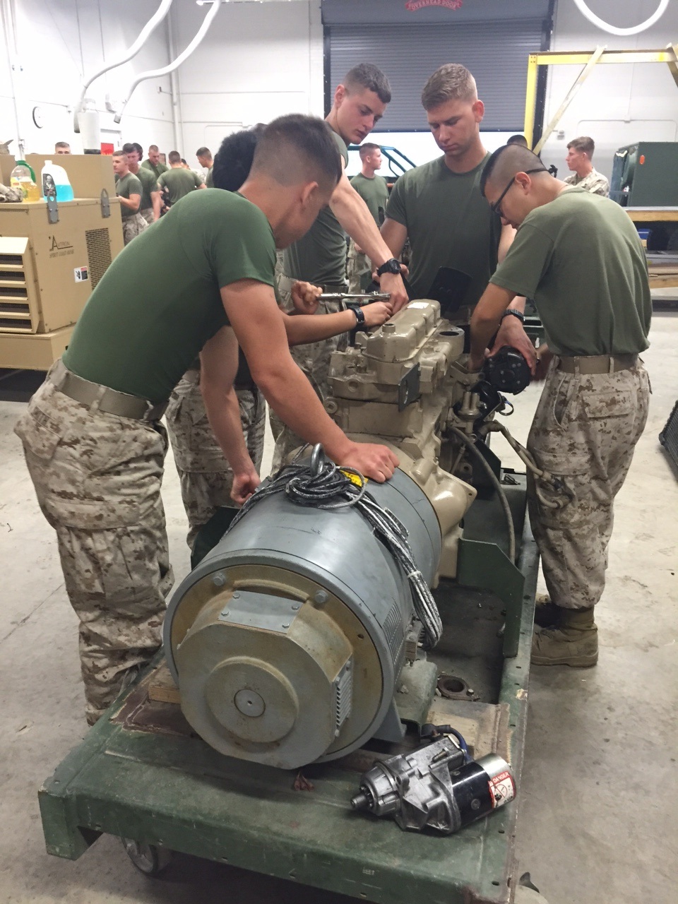 Marines from BEEEST 6-15 conduct practical application on an engine.