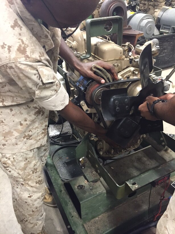 Marines from BEEEST 6-15 conduct practical application on an engine.