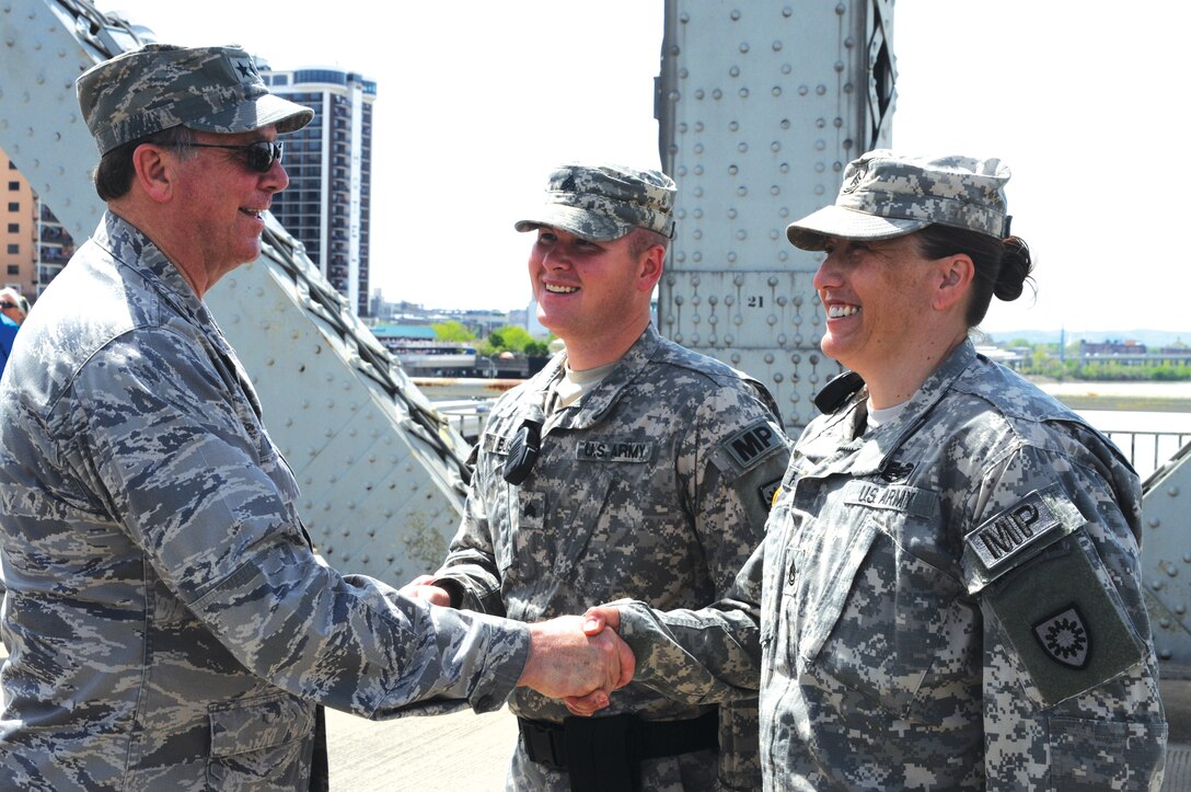 Army Sgt. 1st Class Jennifer Fulkerson, assigned to the 223rd Military Police Company, is congratulated by Kentucky's Adjutant General, Maj. Gen. Edward Tonini after re-enlisting into the Kentucky Army National Guard on April 18, 2015, during the “Thunder Over Louisville” air show. U.S. Army photo by Staff Sgt. David Bolton