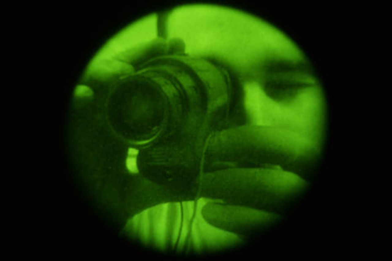 U.S. Air Force Staff Sgt. Scott, an aircrew flight equipment technician assigned to an Expeditionary Operations Support Squadron, inspects monoculars at an undisclosed location in Southwest Asia during Combined Joint Task Force-Operation Inherent Resolve operations, April 15, 2015. Combined Joint Task Force-Operation Inherent Resolve is a multinational effort to weaken and destroy Islamic State of Iraq and the Levant operations in Iraq, Syria, elsewhere in the Middle East, and around the world. U.S. Air Force photo by Tech. Sgt. Christopher Boitz