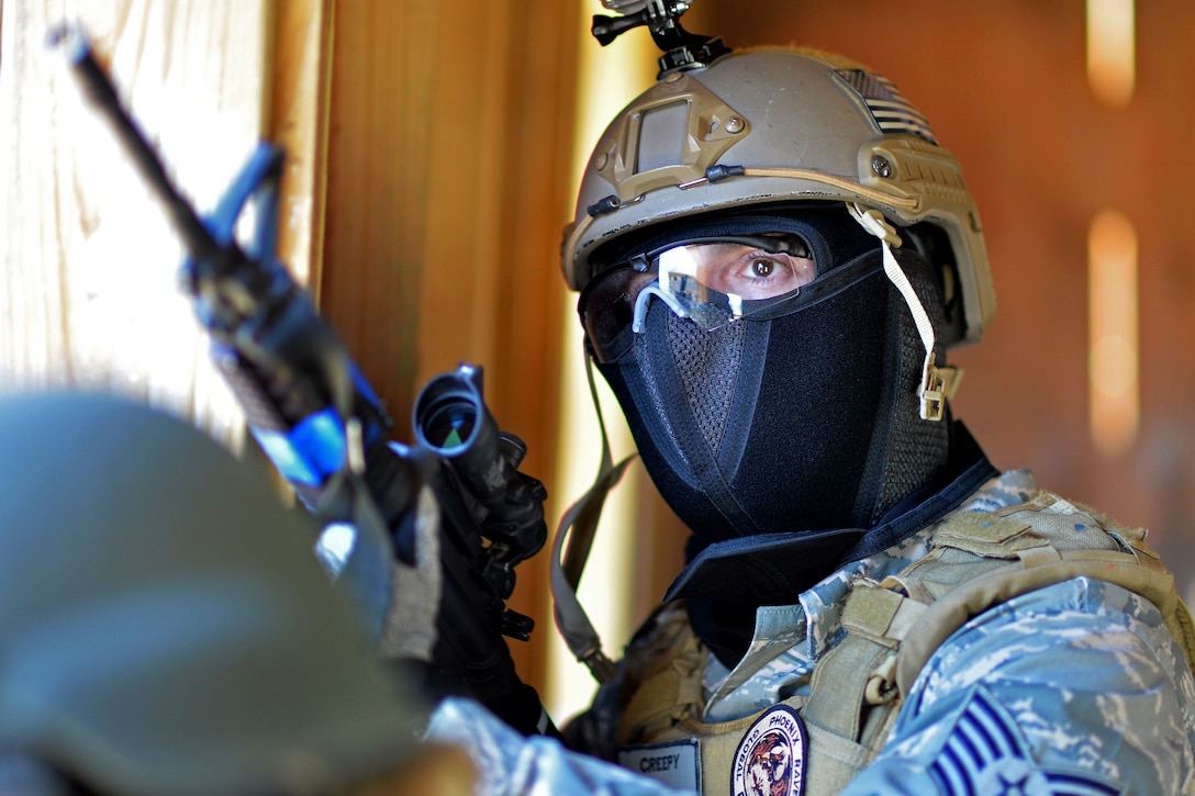 Air Force Tech. Sgt. Terry Maler scans his area after receiving incoming fire during a training exercise on Camp Smith, New York, April 12, 2015. Maler is assigned to the New York Air National Guard's 106th Rescue Wing Security Forces Squadron.