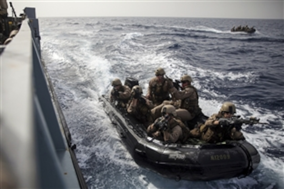 U.S. Marines prepare to board a landing craft from a combat rubber raiding craft during a routine visit, board, search and seizure exercise in the Gulf of Aden, April 9, 2015. The Marines are assigned to the 24th Marine Expeditionary Unit’s Maritime Raid Force.
