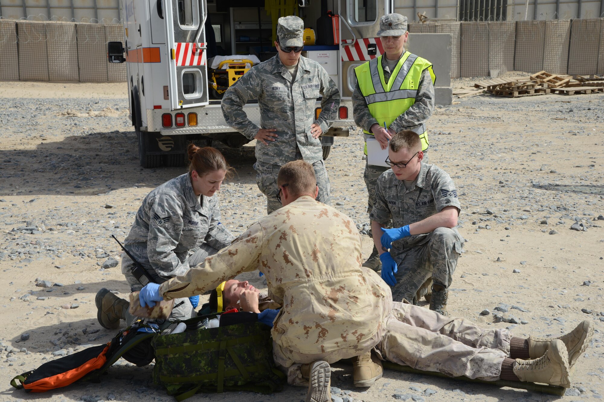 U.S. and Canadian medical personnel evaluate an injured victim of a simulated vehicle accident during a coalition emergency response exercise April 14, 2015. The exercise evaluated the coordination and response between U.S. and Canadian emergency services. (U.S. Air Force photo by Tech. Sgt. Jared Marquis/released)