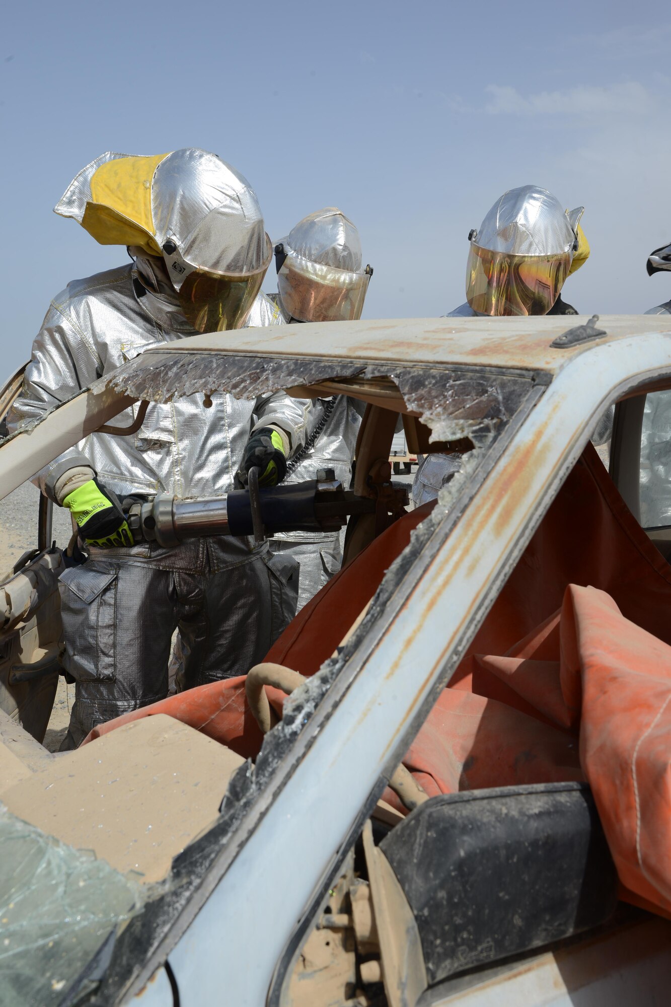 U.S. Air Force firefighters cut into a car to extricate a simulated vehicle accident victim during a U.S. and Canadian emergency response exercise April 14, 2015. The exercise evaluated coalition coordination and response efforts of U.S. and Canadian emergency services. (U.S. Air Force photo by Tech. Sgt. Jared Marquis/released)