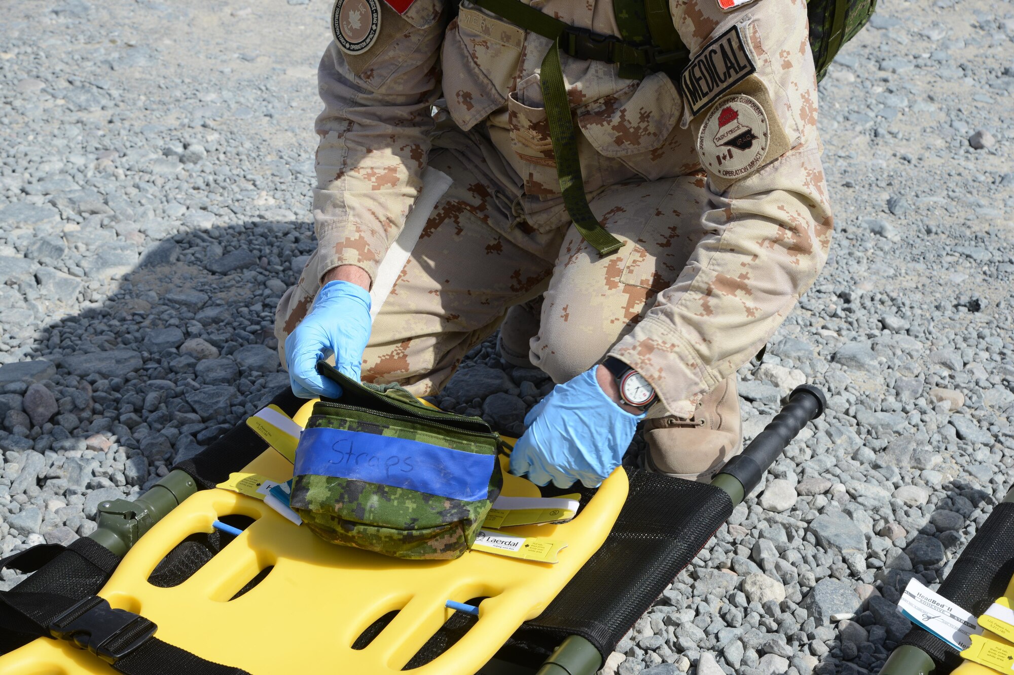 A Canadian emergency medical technician prepares supplies to respond to a simulated vehicle accident during a U.S. and Canadian emergency response exercise April 14, 2015. The exercise evaluated coalition coordination and response efforts of coalition emergency services. (U.S. Air Force photo by Tech. Sgt. Jared Marquis/released)