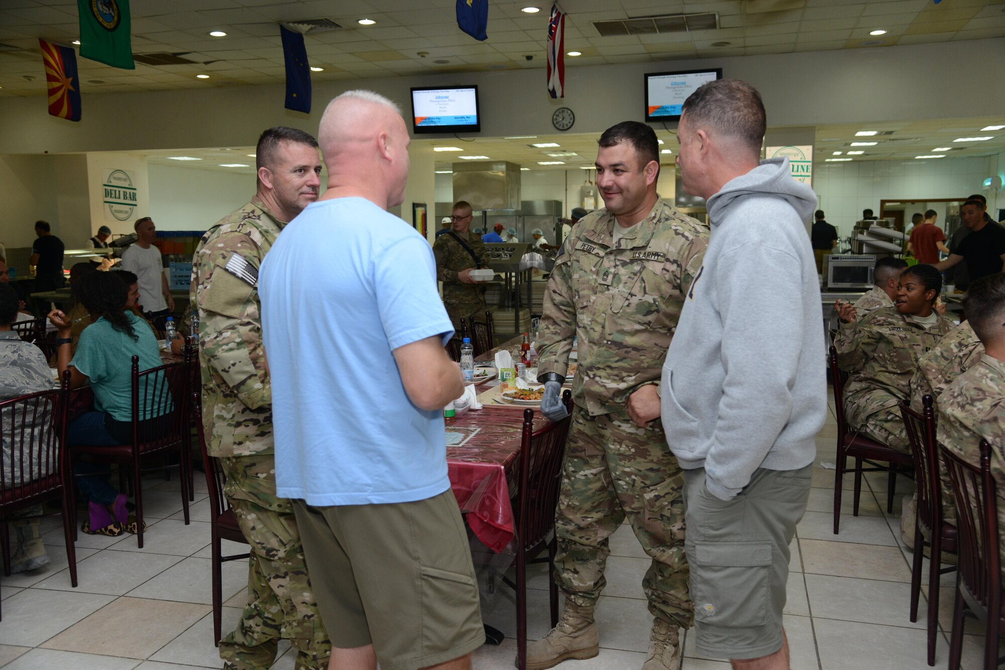 Medal of Honor recipient, retired Army Master Sgt. Leroy Petry visits with service members at The Rock dining facility April 18, 2015. Petry was transitioning through the base after a five-day visit to Afghanistan as part of Operation Proper Exit. Operation Proper Exit, part of the Troops First Foundation, provides the opportunity for wounded warriors to return to the battle space, share their experiences. (U.S. Air Force photo by Tech. Sgt. Jared Marquis/released)