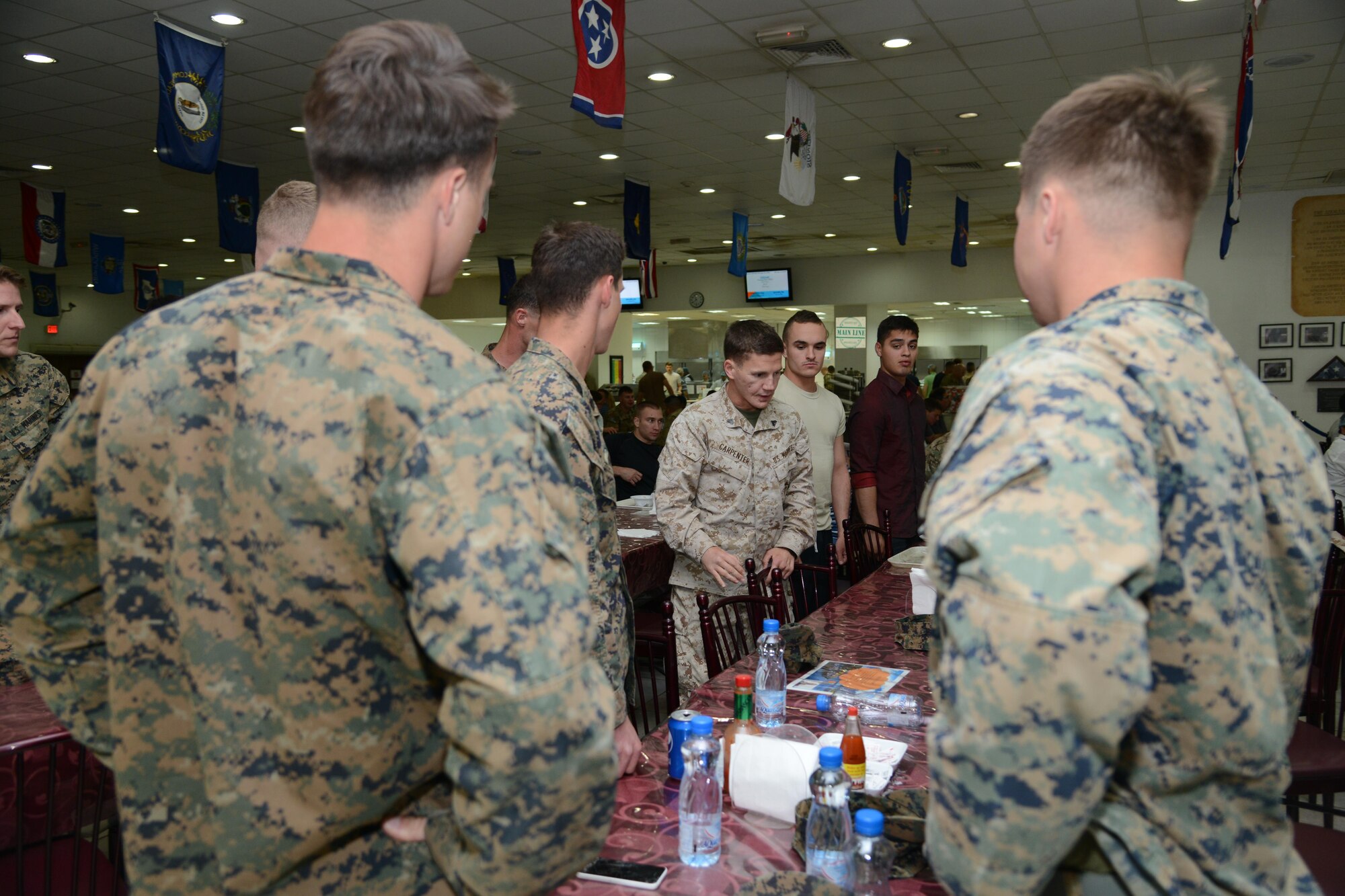 Medal of Honor recipient, retired Marine Cpl. Kyle Carpenter, talks to Marines at The Rock’s Desert Winds dining facility April 18, 2015. Carpenter was transitioning through the base after a five-day visit to Afghanistan as part of Operation Proper Exit. Operation Proper Exit, part of the Troops First Foundation, provides the opportunity for wounded warriors to return to the battle space, share their experiences. (U.S. Air Force photo by Tech. Sgt. Jared Marquis/released)