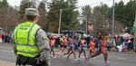 One of the approximately 500 Soldiers and Airmen from the Massachusetts National Guard keeps watch as athletes run the Boston Marathon on April, 20, 2015.