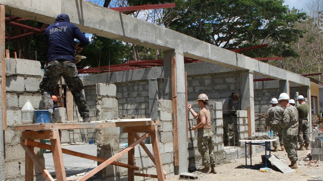 Members of the Armed Forces of the Philippines’ 2nd Naval Mobile Construction Battalion work with members of the U.S. Marine Corps 9th Engineer Support Battalion and U.S. Naval Mobile Construction Battalion 5  to build a two-room classroom at San Rafael Elementary School in the province of San Rafael, on the island of Palawan, Philippines, April 16, as part of exercise Balikatan 2015. This school is one of five buildings being constructed as part of the humanitarian civic assistance projects during the the exercise. Balikatan is an annual bilateral exercise between the AFP and the U.S. military meant to increase combined military-to-military training and build relationships in order to support future engagements. 