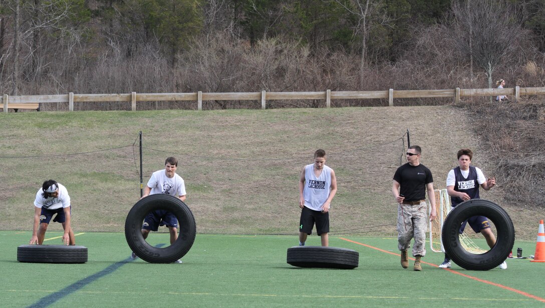 Sgt. Justin Devine, canvassing recruiter with Marine Corps Recruiting Substation Northwest, leads a fireteam of athletes during a leadership seminar with the Vernon Township High School varsity lacrosse team, April 16, 2015.