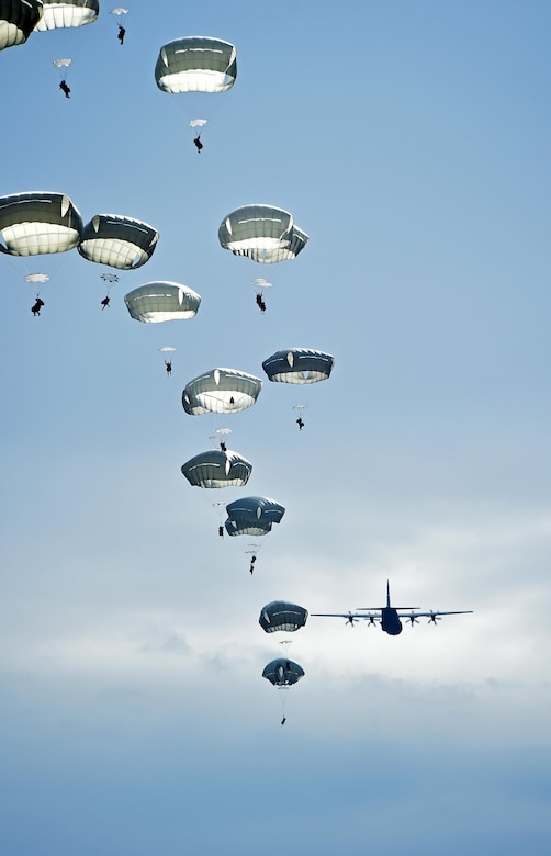 A C-130J Super Hercules assigned to the 317th Airlift Group, Dyess Air Force Base, Texas, airdrops parajumpers from the 2nd Brigade Combat Team, 82nd Airborne Division, April 10, 2015, at Fort Bragg, N.C. During Combined Joint Operational Access Exercise 15-01, U.S. and British mobility aircraft dropped more than 4,500 parajumpers and hundreds of tons of equipment. (U.S. Air Force photo/Senior Airman Peter Thompson)