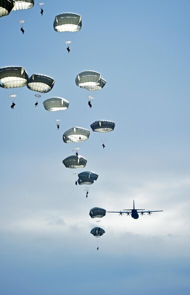 A C-130J Super Hercules assigned to the 317th Airlift Group, Dyess Air Force Base, Texas, airdrops parajumpers from the 2nd Brigade Combat Team, 82nd Airborne Division, April 10, 2015, at Fort Bragg, N.C. During Combined Joint Operational Access Exercise 15-01, U.S. and British mobility aircraft dropped more than 4,500 parajumpers and hundreds of tons of equipment. (U.S. Air Force photo/Senior Airman Peter Thompson)