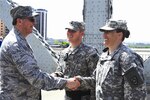 Army Sgt. 1st Class Jennifer Fulkerson, assigned to the 223rd Military Police Company, is congratulated by Kentucky's Adjutant General, Maj. Gen. Edward Tonini after re-enlisting into the Kentucky Army National Guard on April 18, 2015, during the “Thunder Over Louisville” air show. 