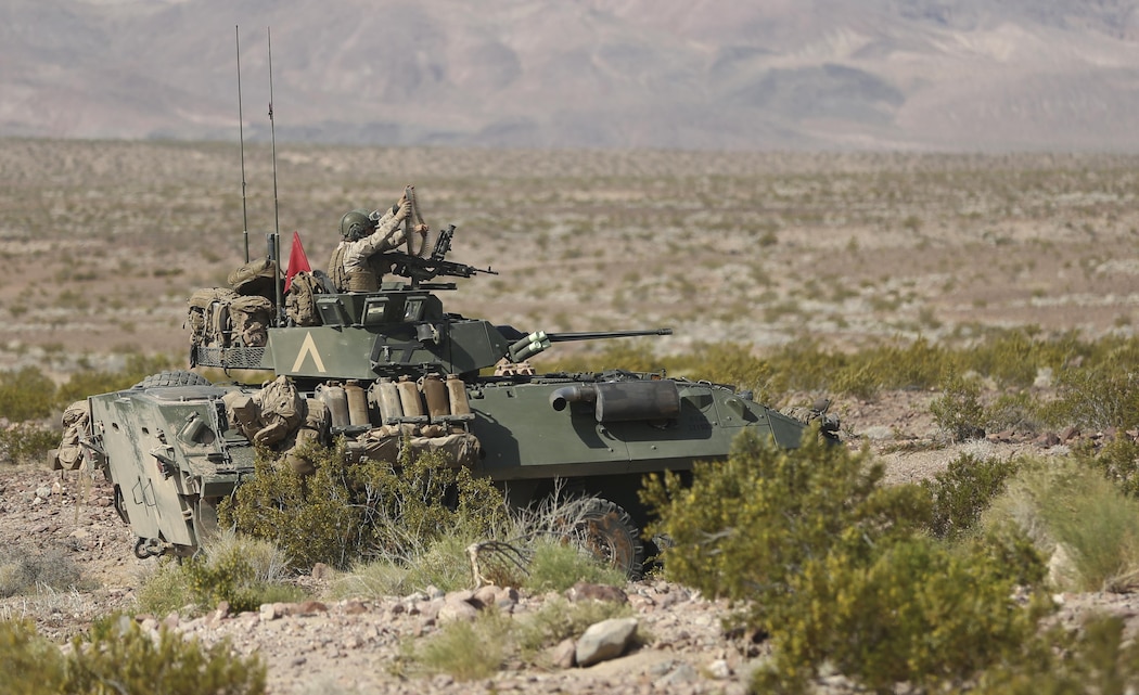 Marines with 3rd Light Armored Reconnaissance Battalion, prepare to fire rounds from a mounted M240B medium machine gun at a target down range during Exercise Desert Scimitar, April 14, 2015. The realistic live-fire training allowed 3rd LAR to train in order to maintain readiness and meet current and future real-world operational demands. (Official Marine Corps photo by Pfc. Levi Schultz/Released)
