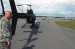 Sgt. Kevin Ressler steadies the tail of an OH-58 Kiowa assigned to the New York Army National Guard's Detachment 1, Co. A, 1st Battalion 224 Security and Support Aviation as he and other maintainers prepare the aircraft for a flight to Stewart Air National Guard Base in Newburgh, N.Y., on Sept. 13, 2010. Ressler, and four other members of the detachment, will accompany the aircraft to the Africa Aerospace and Defense Exposition 2010 in Cape Town, South Africa. The helicopter will be loaded on board a giant C-5A Galaxy belonging to the 105th Airlift Wing of the New York Air National Guard.