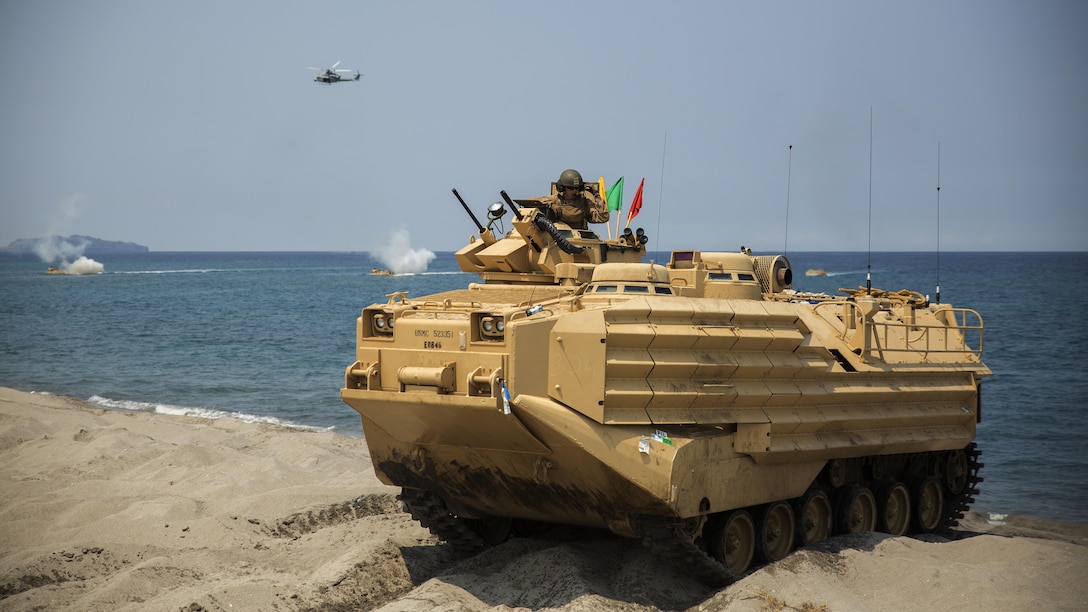 A Marine amphibious assault crewman with 3rd Marine Regiment communicates with other AAVs after landing ashore on North Beach, April 21, at the Naval Education Training Center in Zambales, Philippines, during a bilateral amphibious landing by the Philippine and U.S. Marines as part of exercise Balikatan 2015. Designed to assault any shoreline from the well decks of Navy assault ships, AAVs are highly mobile, tracked armored amphibious vehicles that transport Marines and cargo to and through hostile territory. Balikatan, which translates to “shoulder-to-shoulder” in Filipino, is an annual bilateral exercise between the AFP and the U.S. military, which focuses on improving security cooperation activities, humanitarian assistance and disaster relief capabilities, and crisis response throughout the region in accordance with the Mutual Defense Board and Security Engagement Board.