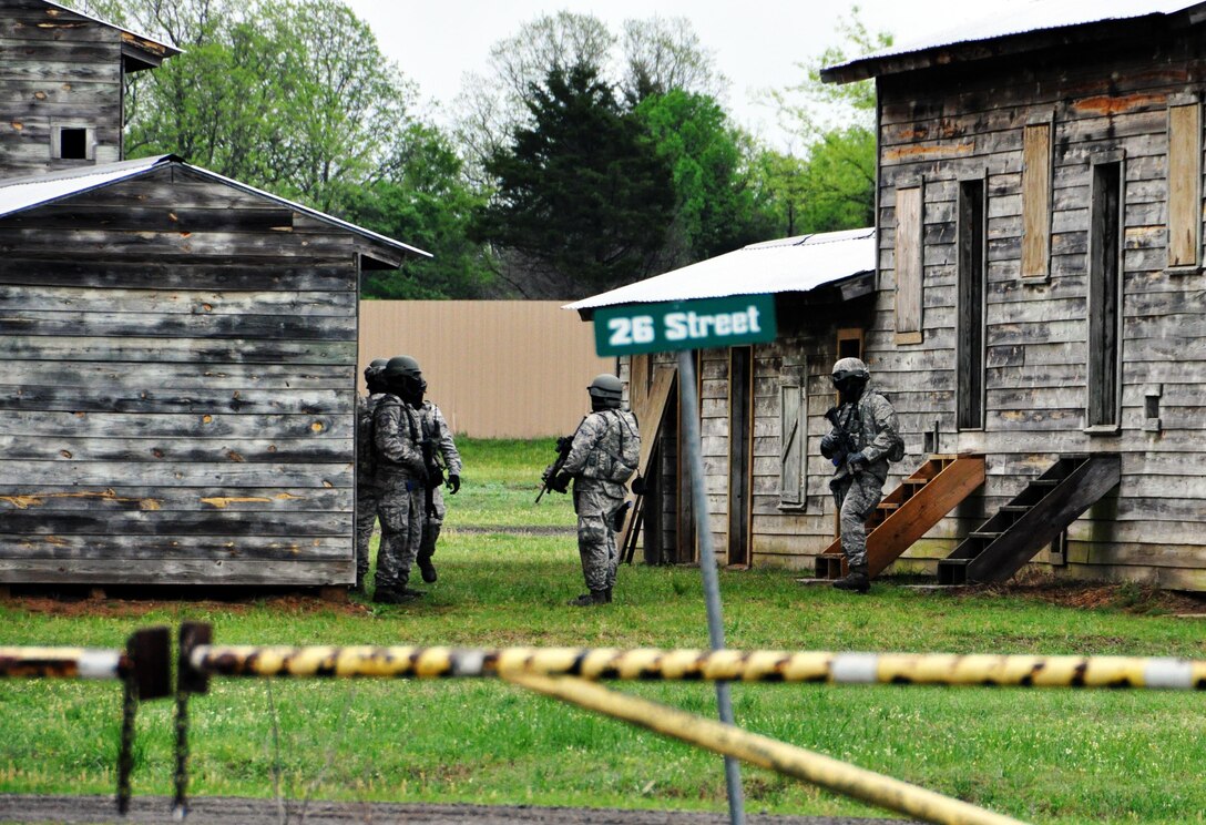 Members of the 931st Security Forces Squadron and 931st Civil Engineer Squadron maintain security after securing an area during a military operations on urban terrain (MOUT) exercise at Camp Gruber Training Center, Okla., April 15, 2015. More than 80 members of the two squadrons participated in ten days of combat skills training at Camp Gruber, which included land navigation, weapons training, tactical movements, convoy operations, base defense, room clearing procedures, foot patrols, military operations on urban terrain (MOUT) and combat lifesaving. (U.S. Air Force photo by Capt. Zach Anderson) 
