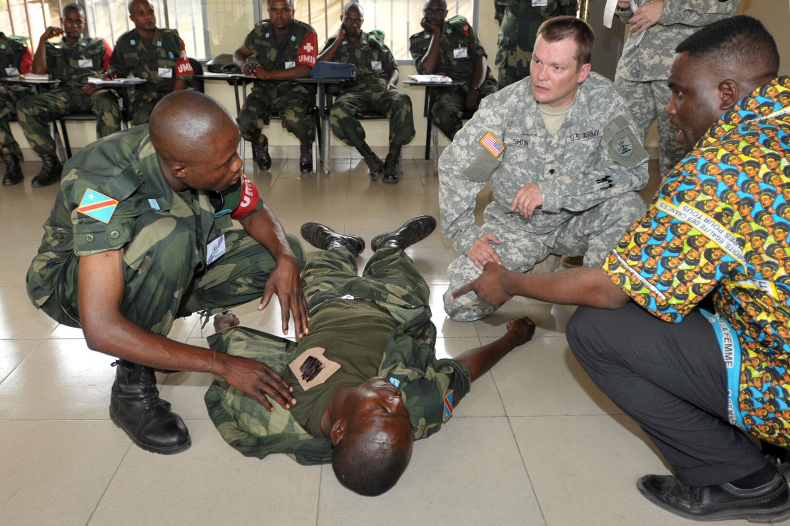 Spc. Ricky Smith of the North Dakota National Guard teaches members of the Armed Forces of the Democratic Republic of Congo how to evaluate a casualty. Smith, a member of the 814th Army Medical Support Company, Detachment 1, based in Grand Forks N.D., is in Congo as part of MEDFLAG 10 a joint military training exercise between the U.S. military and FARDC soldiers to enhance emergency response capabilities in the region.