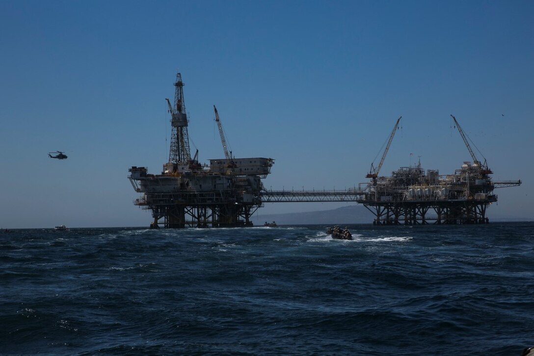 U.S. Marines with the 15th Marine Expeditionary Unit’s Maritime Raid Force approach a gas-oil platform during Certification Exercise (CERTEX) off the coast of Los Angeles April 17, 2015. The MRF inserted the GOPLAT with a helicopter-assault force and boat-assault force to execute a top-down, bottom-up clear of the structure. (U.S. Marine Corps photo by Cpl. Anna Albrecht/Released)