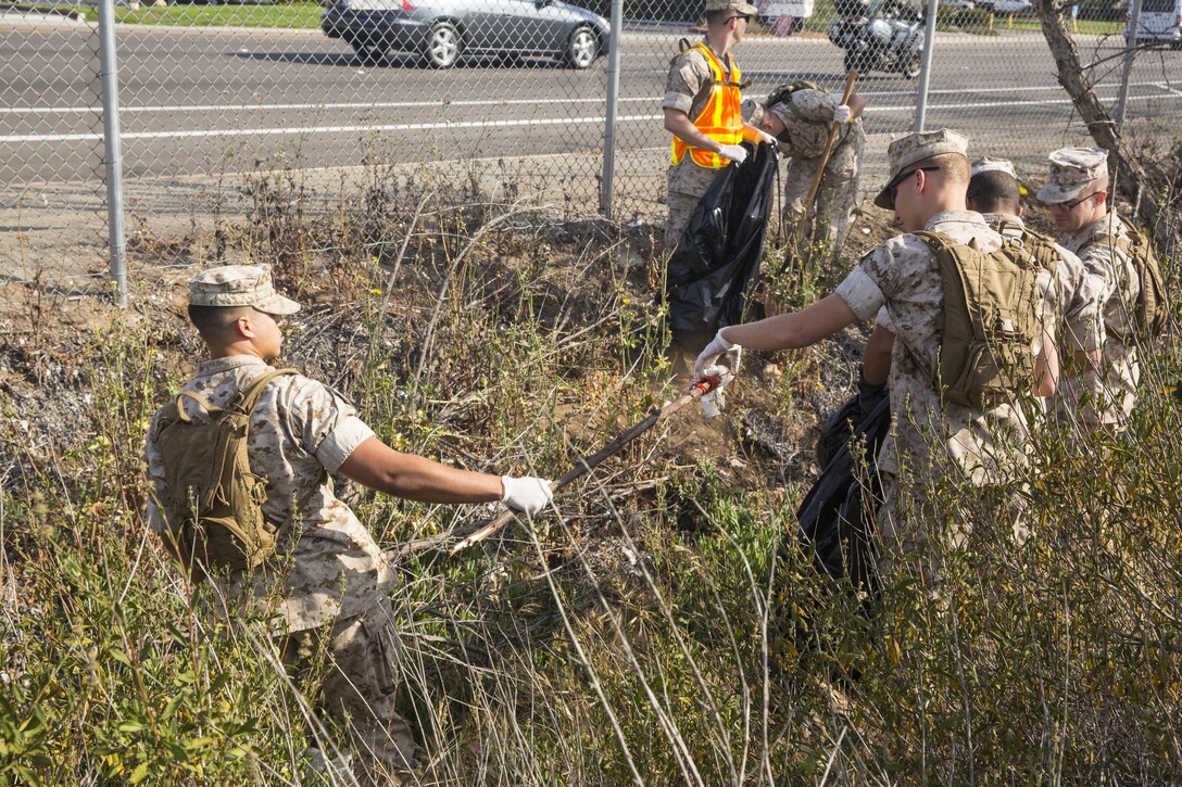 Marines with Marine Corps Air Station Miramar and the 3rd Marine Aircraft Wing pick up trash during a station-wide cleanup aboard MCAS Miramar, California, April 20. More than 250 service members were divided into six groups and each group was responsible for cleaning a sector of the base.