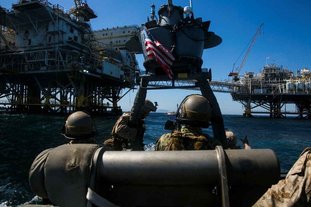 U.S. Marines with the 15th Marine Expeditionary Unit’s Maritime Raid Force and Sailors with Essex Amphibious Ready Group approach a gas-oil platform during Certification Exercise (CERTEX) off the coast of Los Angeles April 17, 2015. These Marines and Sailors worked side-by-side to execute a simulated raid aboard the GOPLAT in preparation for their upcoming deployment. (U.S. Marine Corps photo by Cpl. Anna Albrecht/Released)