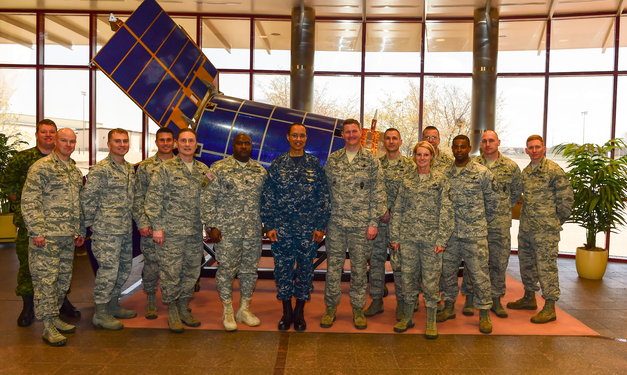U.S. Navy Adm. Cecil D. Haney (center), U.S. Strategic Command commander, and U.S. Army Command Sgt. Maj. Patrick Z. Alston (center left), USSTRATCOM senior enlisted leader, met with members of the 460th Operations Group, 2nd Space Warning Squadron, and international partners during a visit to Buckley Air Force Base, Colo., April 20, 2015. During their visit, Haney and Alston toured Buckley’s missile warning facilities and met with Airmen and Sailors from the base to discuss their role in supporting USSTRATCOM’s global strategic missions. USSTRATCOM is one of nine DoD unified combatant commands and is charged with strategic deterrence; space operations; cyberspace operations; joint electronic warfare; global strike; missile defense; intelligence, surveillance and reconnaissance; combating weapons of mass destruction; and analysis and targeting. (U.S. Air Force photo by Amn. 1st Class Luke W. Nowakowski)