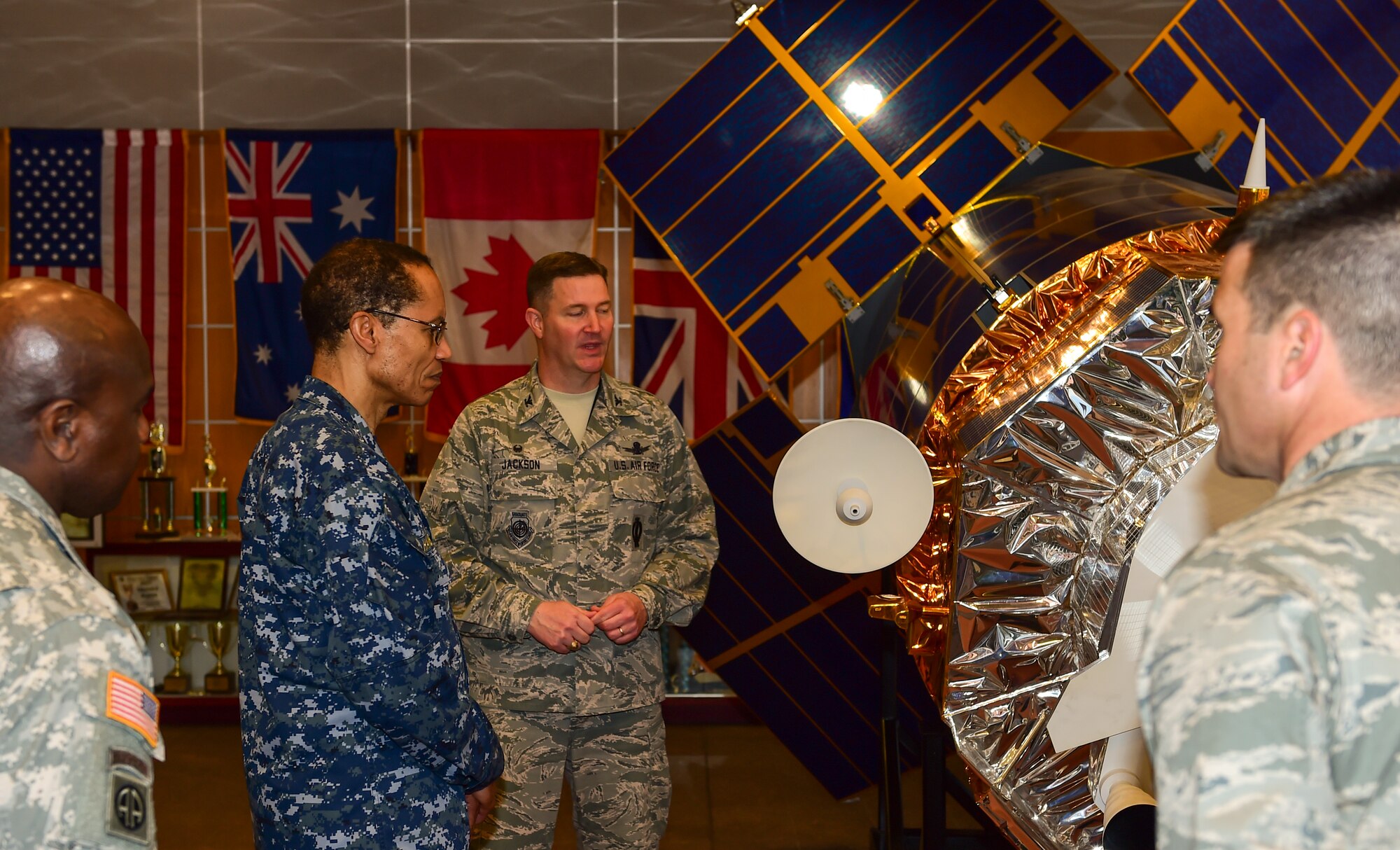 U.S. Navy Adm. Cecil D. Haney (second from left), U.S. Strategic Command commander, and U.S. Army Command Sgt. Maj. Patrick Z. Alston (left), USSTRATCOM senior enlisted leader, receive a mission brief from U.S. Air Force Col. Michael Jackson, 460th Operations Group commander, while viewing a Defense Satellite Program satellite model during their trip to Buckley Air Force Base, Colo., April 20, 2015. In addition to touring Buckley’s missile warning facilities, Haney and Alston met with Airmen and Sailors from the base to discuss their role in supporting USSTRATCOM’s global strategic missions. USSTRATCOM is one of nine DoD unified combatant commands and is charged with strategic deterrence; space operations; cyberspace operations; joint electronic warfare; global strike; missile defense; intelligence, surveillance and reconnaissance; combating weapons of mass destruction; and analysis and targeting. (U.S. Air Force photo by Amn. 1st Class Luke W. Nowakowski)