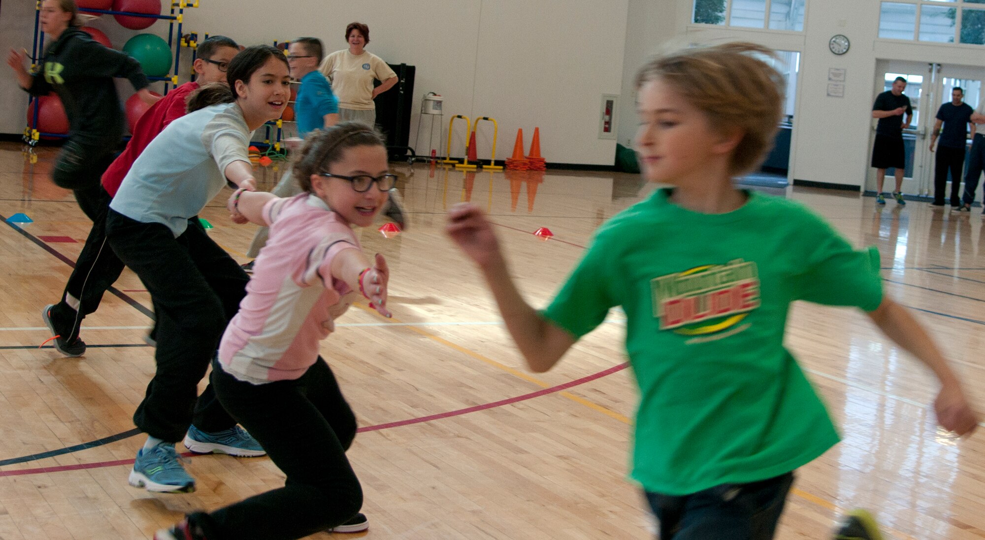 Seth Boyten, 10, son of Jason Boyten, avoids Isabel McCord, 11, daughter of Tech. Sgt. Anthony Balser, 90th Missile Security Forces Squadron, while playing a game of octopus April 18, 2015, during the 90th Force Support Squadron Family Fun Competition event in the Freedom Hall Fitness Center F.E. Warren Air Force Base, Wyo. Children raced across the basketball court as they tried to avoid the octopus, three people who are linked together. (U.S. Air Force photo by Airman 1st Class Brandon Valle)
