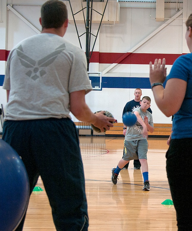 Aaron Haynes, 11, son of Andrew Haynes, 90th Maintenance Group, throws a ball in an attempt to knock down another ball during the 90th Force Support Squadron Family Fun Competition event in the Freedom Hall Fitness Center, F.E. Warren Air Force Base, Wyo.,  April 18, 2015. Families competed in a number of events to receive raffle tickets for prizes at the end of the competition. (U.S. Air Force photo by Airman 1st Class Brandon Valle)