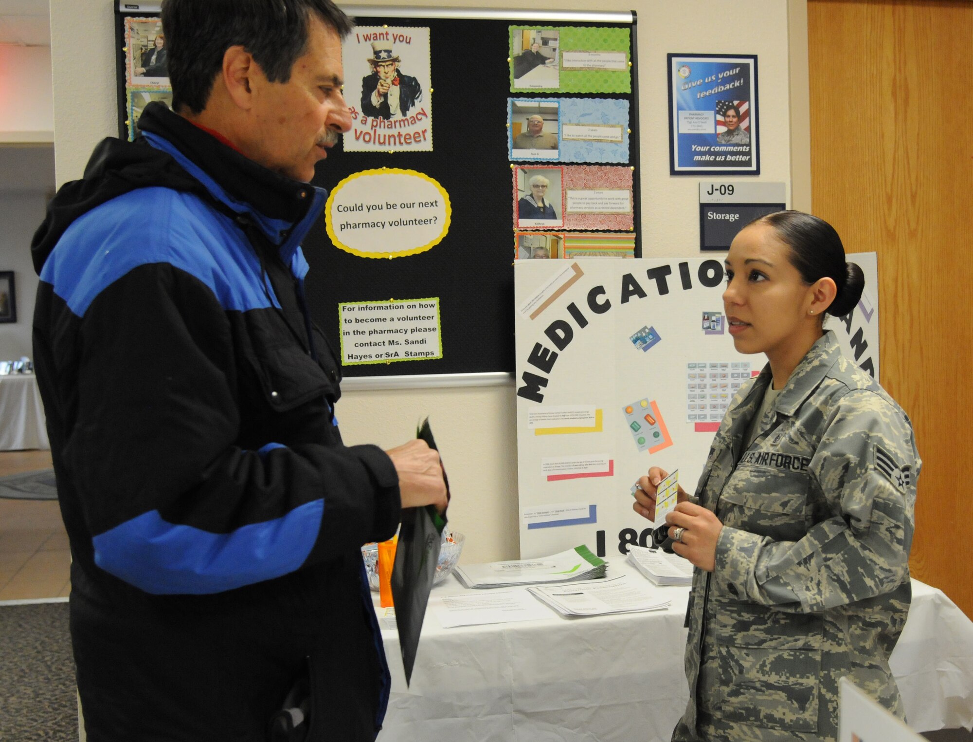 Senior Airman Joanna Stamps, 90th Medical Support Squadron pharmacist, provides pharmacy information to Dale Woodward in the Medical Treatment Facility on F.E. Warren Air Force Base, Wyo., April 18, 2015 during a Retiree Appreciation Day event. Airmen manned informational booths to explain services the base has to offer retirees. (U.S. Air Force photo by Airman 1st Class Malcolm Mayfield)