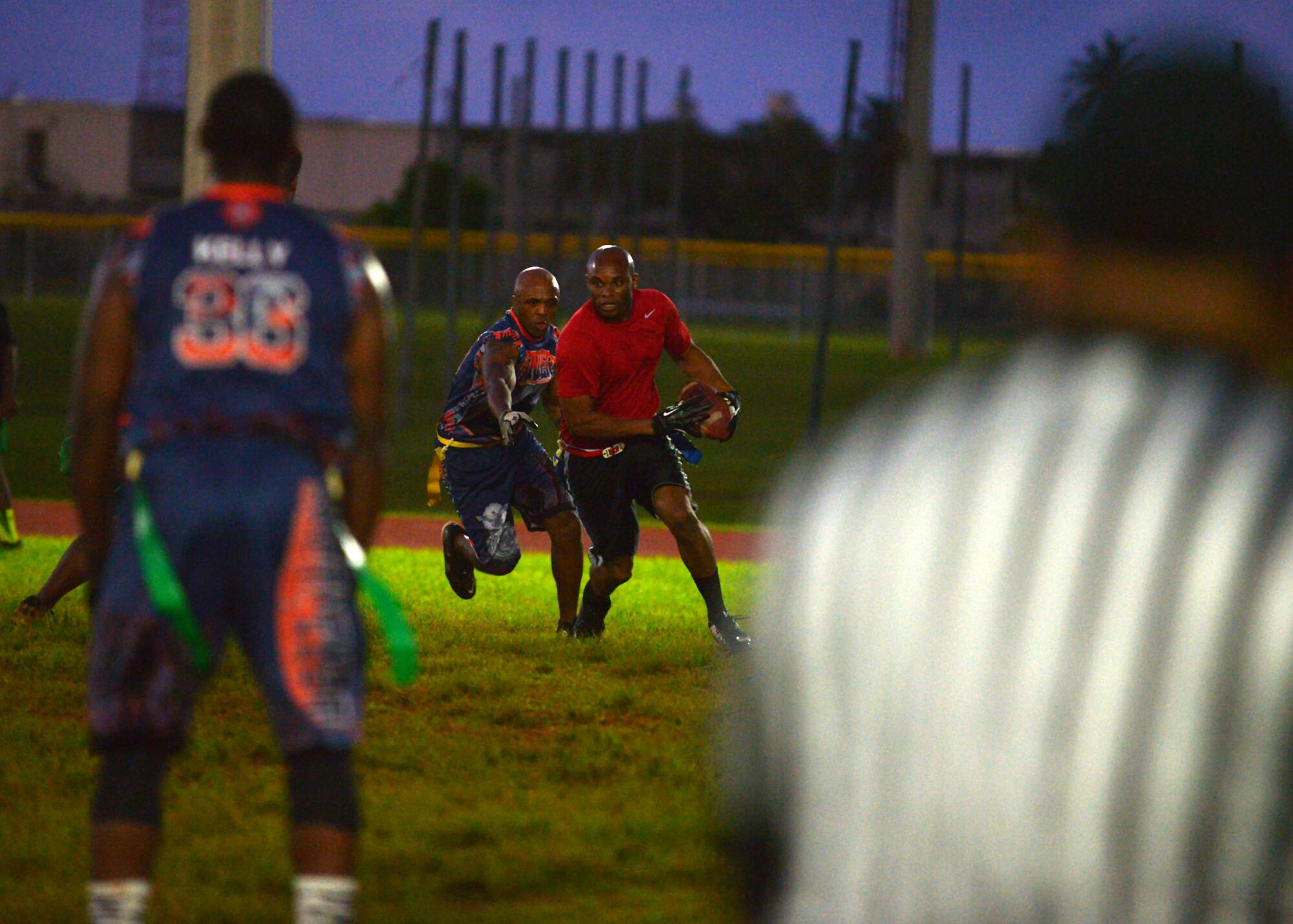 A 664th Combat Communications Squadron attempts to run for a first down during the flag football championship, April 20, 2015. The 36th SFS defeated the 664th CBCS 14-0 in the championship. (U.S. Air Force photo by Airman 1st Class Joshua Smoot/Released)