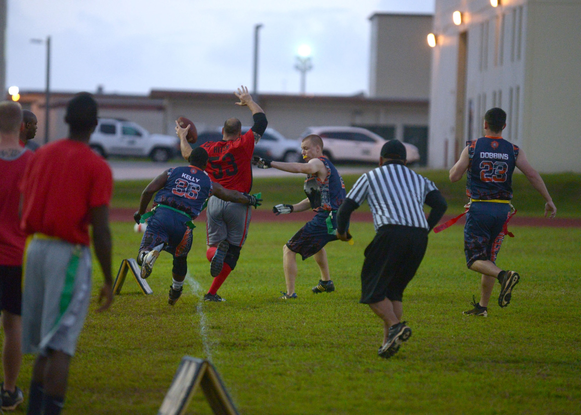 A 36th Security Forces Squadron member attempts to pull a flag from a 664th Combat Communications member as he tip-toes along the sideline during the flag football championship, April 20, 2015. The 36th SFS defeated the 664th CBCS 14-0 in the championship. (U.S. Air Force photo by Airman 1st Class Joshua Smoot/Released)