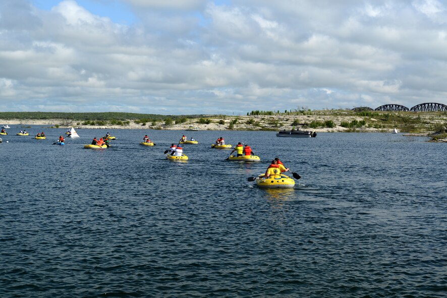 Competitors, at the Adventure Race XI, raft in the water at the Laughlin Southwinds Marina near Del Rio, Texas, April 18, 2015. Nearly 200 people, from the Val Verde County and surrounding cities, participated in the Adventure Race, which included a 3.5-mile run with three mystery challenges, a 23-mile bicycle ride and a mile-long water rafting portion. (U.S. Air Force photo by Airman Brandon May)