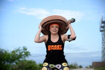 Blanca Montemayor Ozuna, Del Rio citizen and 2 Fast 6 Furious team member, conducts a physical challenge during the Laughlin Adventure Race XI on Laughlin Air Force Base, Texas, April 18, 2015. The run portion of the race included three mystery challenges along the route, including paintballing, tire jumps, and weighted squats. (U.S. Air Force photo by Airman 1st Class Ariel D. Partlow)