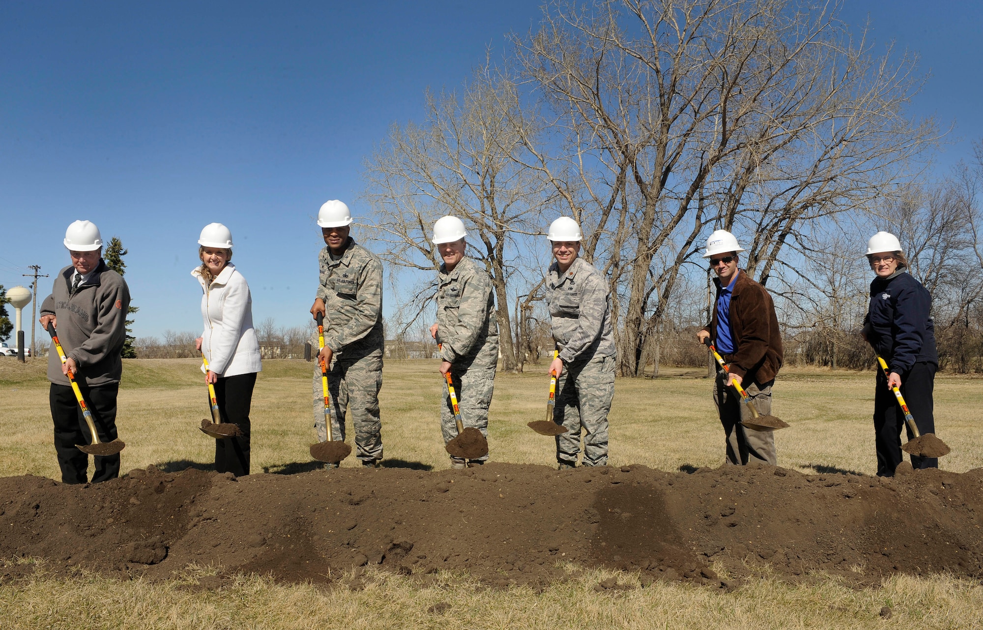 Base leadership and the project contractor pose for a photo during a ground breaking ceremony for a new temporary lodging facility on Minot Air Force Base, N.D., April 20, 2015. The estimated completion date for construction is August 18, 2016 and the grand opening is projected for October 2016. (U.S. Air force photo/Senior Airman Stephanie Morris)