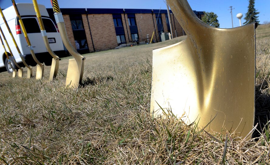 Shovels stand in a row during a ground breaking ceremony for a new temporary lodging facility on Minot Air Force Base, N.D., April 20, 2015. The ceremony marked the beginning of construction for the new 30-unit building. (U.S. Air force photo/Senior Airman Stephanie Morris)