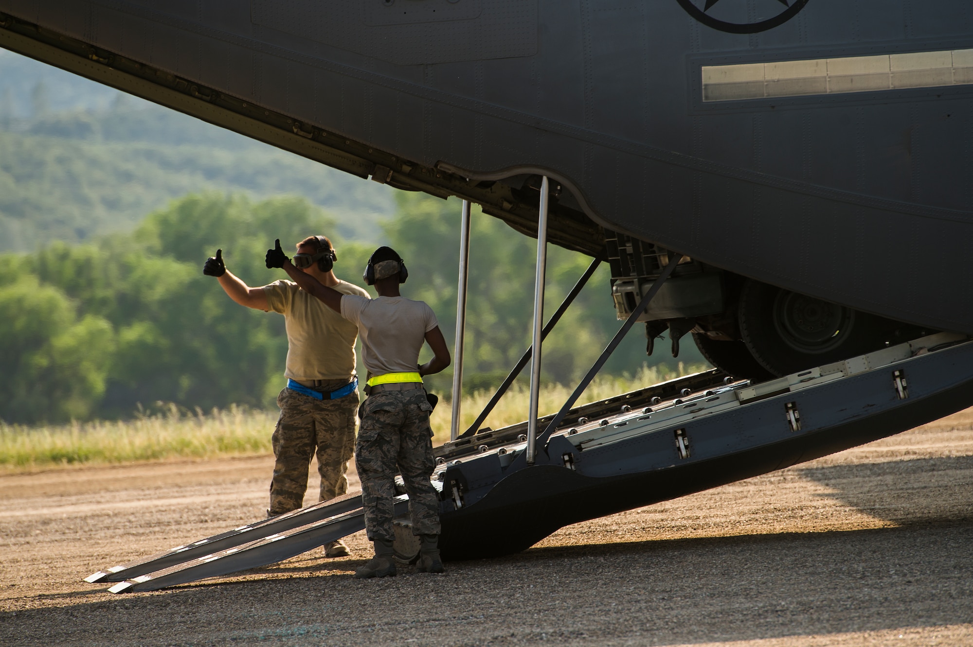 Airmen with the 570th Global Mobility Squadron,  download cargo from a C-130 Hercules aircraft at Fort Hunter Liggett, Calif. during Exercise Golden Hydra on March 31, 2015. (Photo by U.S. Air Force Photojournalist Tech. Sgt. Matthew Hannen)  