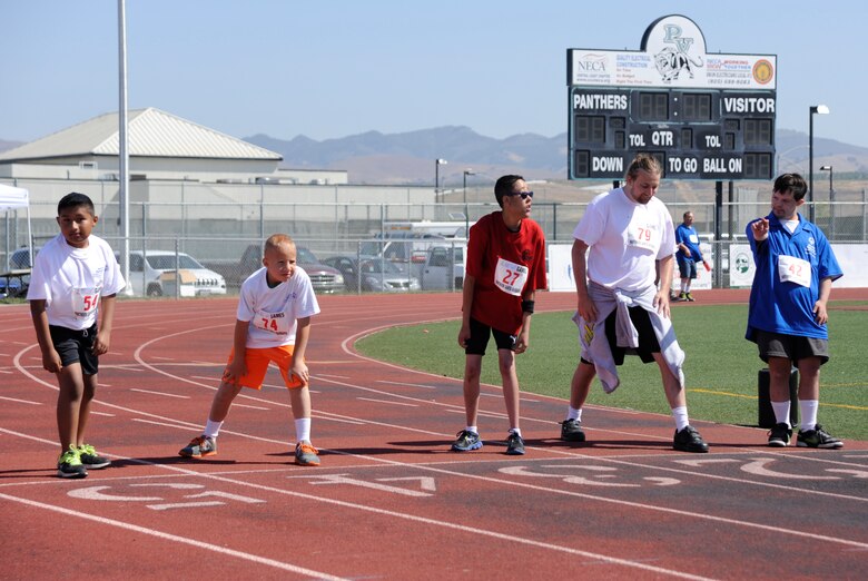 Athletes prepare to run the 100-meter dash at a Special Olympics event, April 18, 2015, Santa Maria, Calif. More than 60 Team V Airmen joined forces with members of Special Olympics Northern Santa Barbara County to assist with the event. (U.S. Air Force Photo by Airman Robert J. Volio/Released)