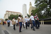 The 2015 military ambassadors carry a wreath and follow the processional April 20 during the annual Fiesta San Antonio Pilgrimage to the Alamo, a memorial tribute to the Alamo heroes and the heritage of Texas. The wreath-bearing procession is a solemn occasion during which historic, civic, patriotic, military and school groups walk silently to the Alamo carrying wreaths, which are placed at the Alamo. (U.S. Air Force photo by Joel Martinez)