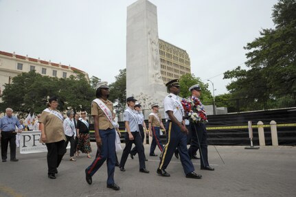 The 2015 military ambassadors carry a wreath and follow the processional April 20 during the annual Fiesta San Antonio Pilgrimage to the Alamo, a memorial tribute to the Alamo heroes and the heritage of Texas. The wreath-bearing procession is a solemn occasion during which historic, civic, patriotic, military and school groups walk silently to the Alamo carrying wreaths, which are placed at the Alamo. (U.S. Air Force photo by Joel Martinez)