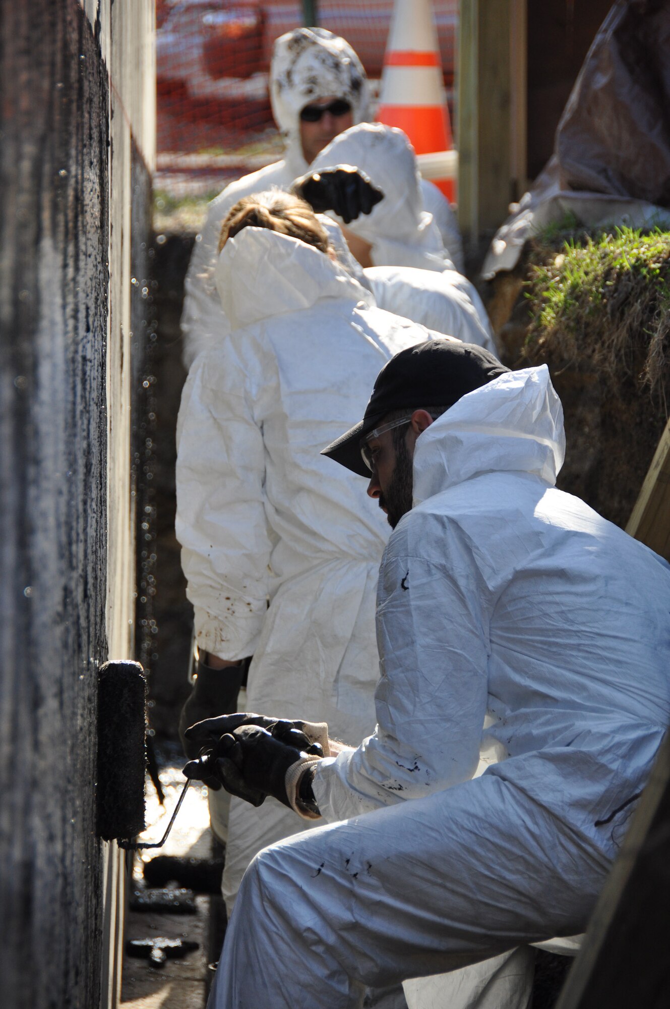 Members of the New York Air National Guard's 105th Airlift Wing and Boeing Company use their off-duty time to waterproof a house being built by Habitat for Humanity in Newburgh, N.Y., April 18,2015. The Airmen are members of the Wing's First Six Council, a group for junior Airmen. (U.S. Air National Guard photo by Maj. Patrick Cordova/Released)