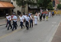 The 2015 military ambassadors carry a wreath and follow the processional April 20 during the annual Fiesta San Antonio Pilgrimage to the Alamo, a memorial tribute to the Alamo heroes and the heritage of Texas. The wreath-bearing procession is a solemn occasion during which historic, civic, patriotic, military and school groups walk silently to the Alamo carrying wreaths, which are placed at the Alamo. (U.S. Air Force photo by Joel Martinez)