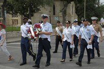 The 2015 military ambassadors carry a wreath and follow the processional April 20 during the annual Fiesta San Antonio Pilgrimage to the Alamo, a memorial tribute to the Alamo heroes and the heritage of Texas. The wreath-bearing procession is a solemn occasion during which historic, civic, patriotic, military and school groups walk silently to the Alamo carrying wreaths, which are placed at the Alamo. (U.S. Air Force photo by Joel Martinez)