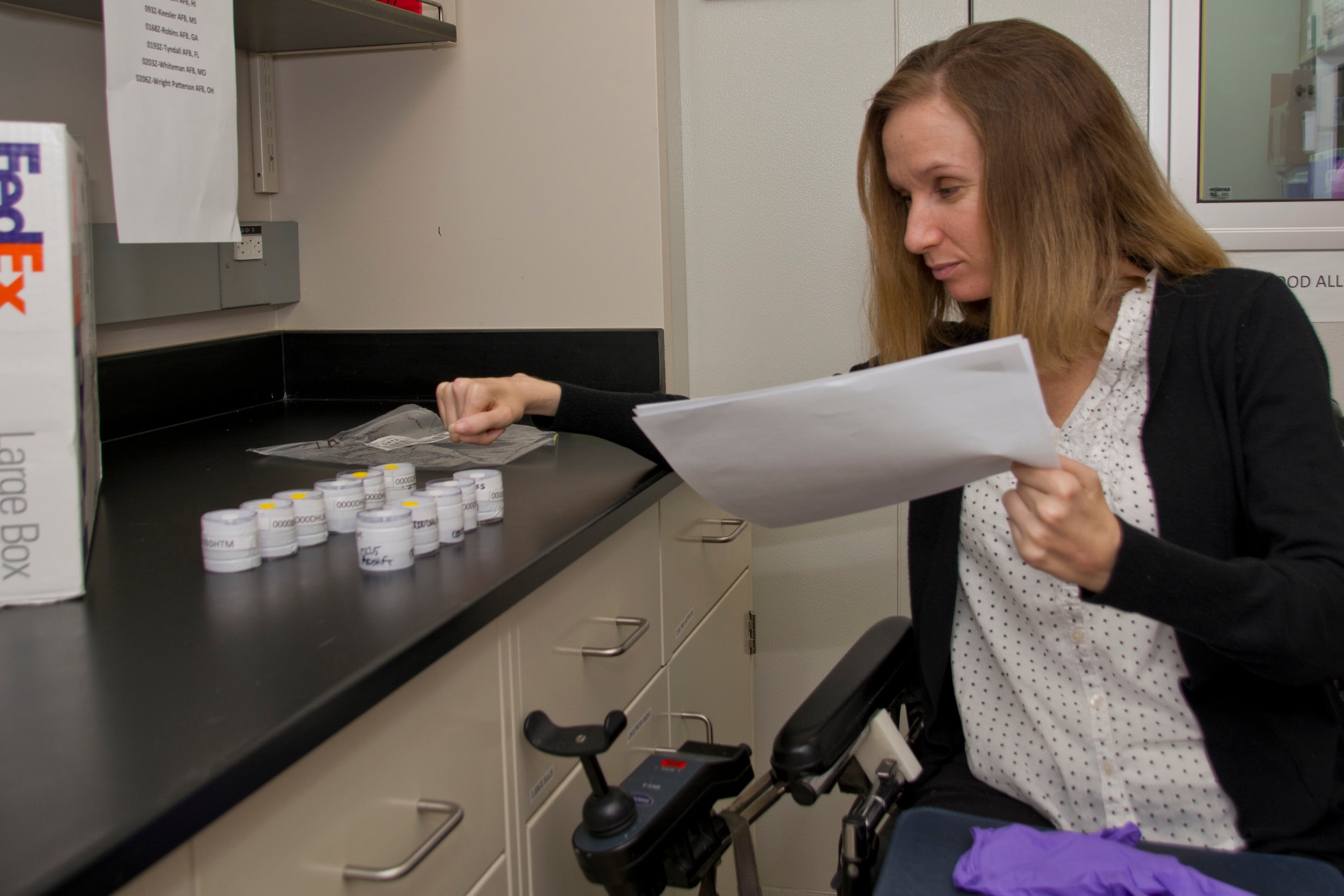 Holly Slack examines samples and reviews paperwork to ensure suitability for analysis. (U.S. Air Force photo by Richard Eldridge)