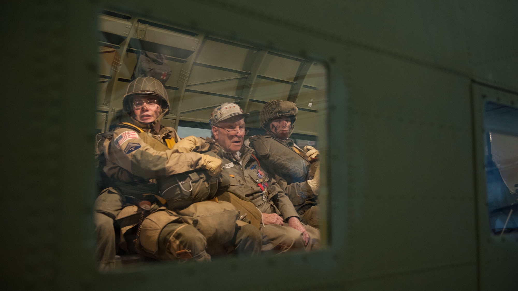 George Shenkle sits in between Daniel Dillier and Christian Holland, re-enactors depicting World War II-era paratroopers from the 82nd Airborne Division, onboard a C-47A Skytrain April 18, 2015, at the Air Mobility Command Museum near Dover Air Force Base, Del. (U.S. Air Force photo/Airman 1st Class Zachary Cacicia)