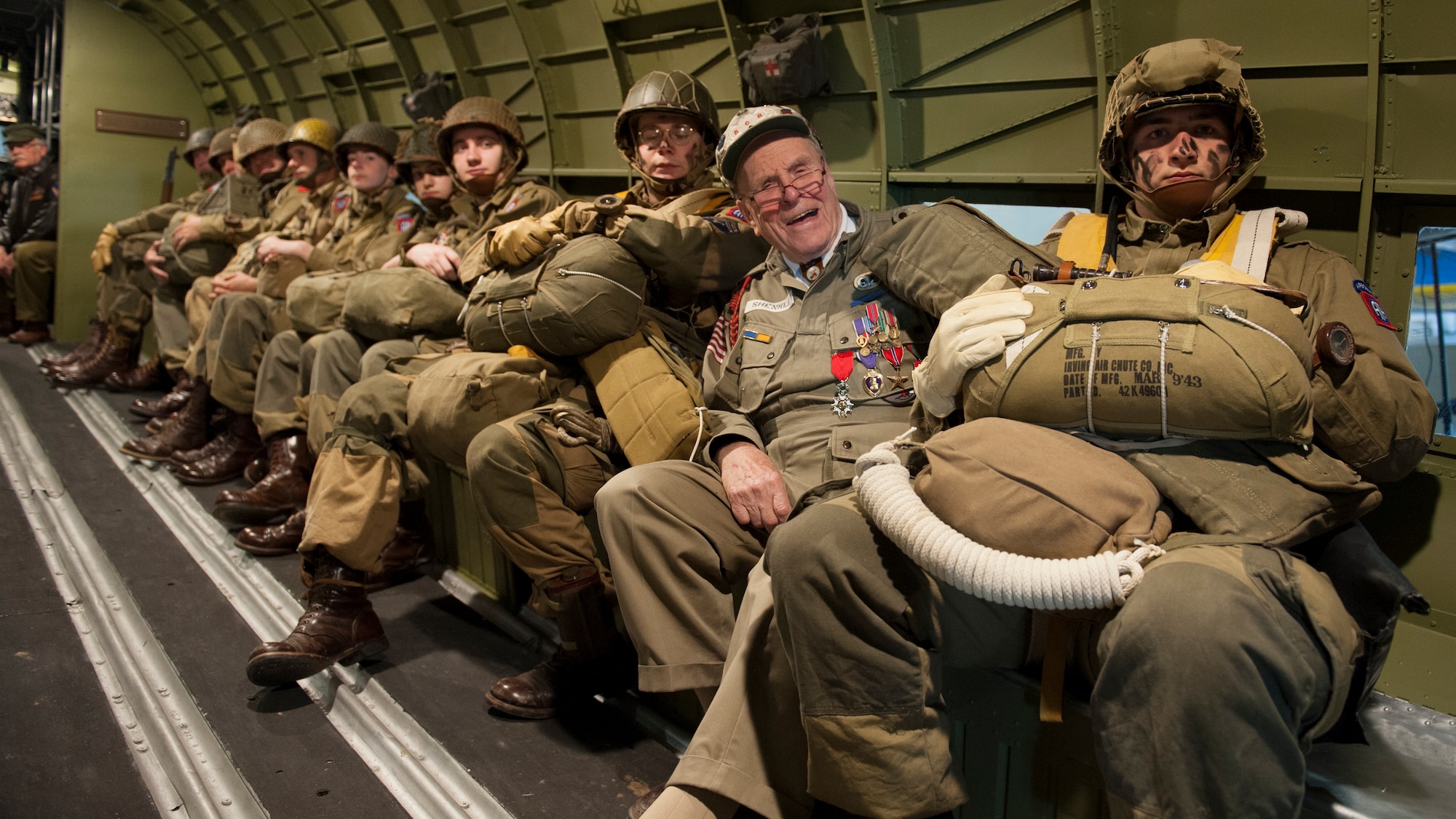 George Shenkle sits with re-enactors, who are depicting World War II-era paratroopers from the 82nd Airborne Division, inside a C-47A Skytrain April 18, 2015, at the Air Mobility Command Museum near Dover Air Force Base, Del. Shenkle is sitting in the same seat position on the very aircraft that he jumped out of on D-Day, June 6, 1944, over Normandy, France. (U.S. Air Force photo/Airman 1st Class Zachary Cacicia)